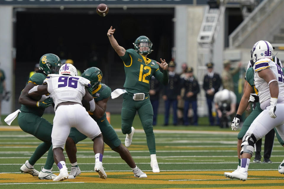 Baylor quarterback Blake Shapen (12) throws a touchdown pass to teammate Monaray Baldwin with blocking from teammates against Albany defense during the first half of an NCAA college football game in Waco, Texas, Saturday, Sept. 3, 2022. (AP Photo/LM Otero)