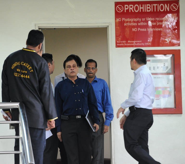 Officials leave the mortuary room after identifying the body of an Indian gang-rape victim from New Delhi who died overnight, at Singapore General Hospital, on December 29, 2012. The victim, 23, died overnight after suffering severe organ failure, the hospital treating her said, in a case that sparked widespread street protests over violence against women