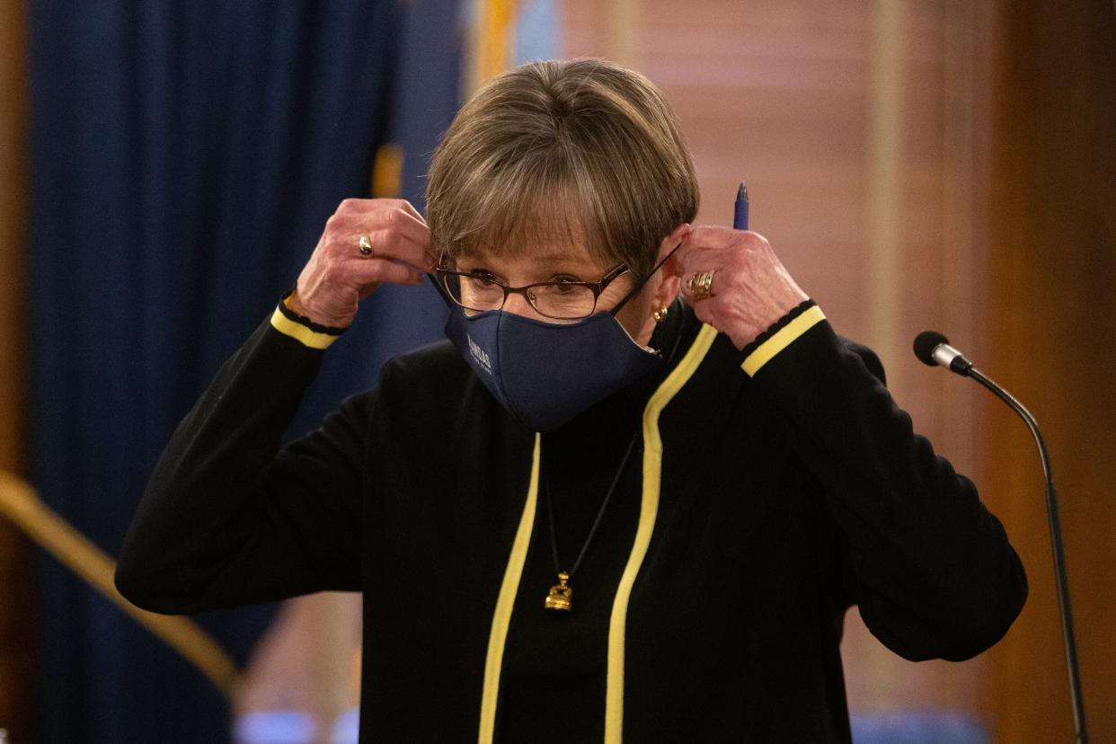 Gov. Laura Kelly puts her mask back on after taking questions at a January press conference at the Statehouse.