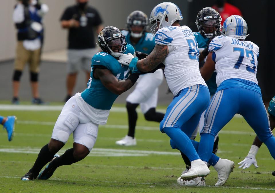 Detroit Lions tackle Taylor Decker holds the line against Jacksonville Jaguars linebacker K'Lavon Chaisson during the first quarter at TIAA Bank Field, Oct. 18, 2020.