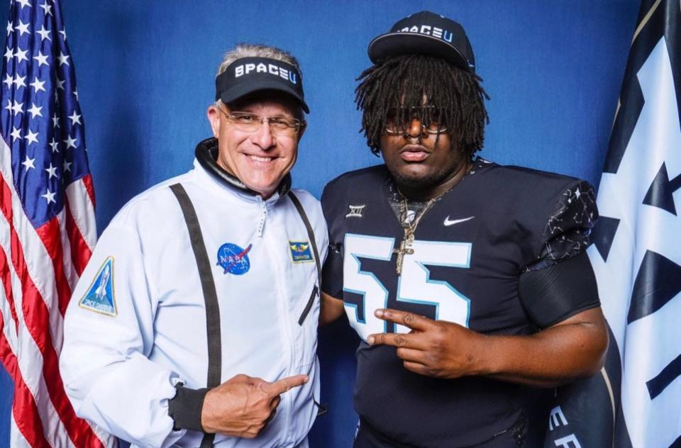 Tampa Catholic interior offensive lineman Eddy Pierre-Louis (55) poses with UCF football coach Gus Malzahn during his official visit from June 2-4.