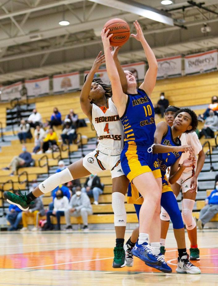 Henry Clay’s Allison Stone grabbed a rebound away from Mikalee Bennett during a game last season.