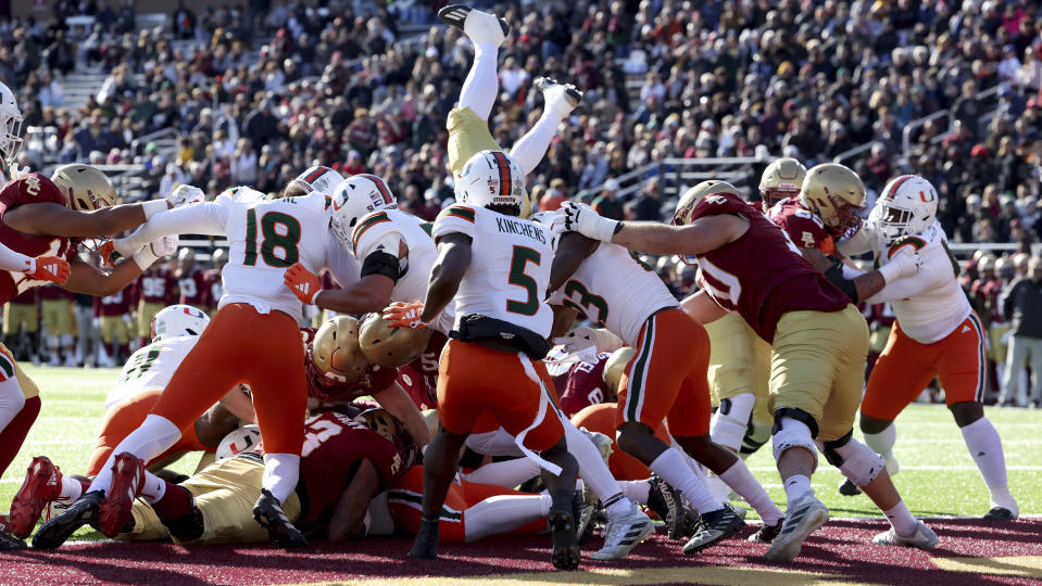 Boston College running back Kye Robichaux flips into the end zone to score during the first half of an NCAA college football game against Miami, Friday, Nov. 24, 2023 in Boston. (AP Photo/Mark Stockwell)