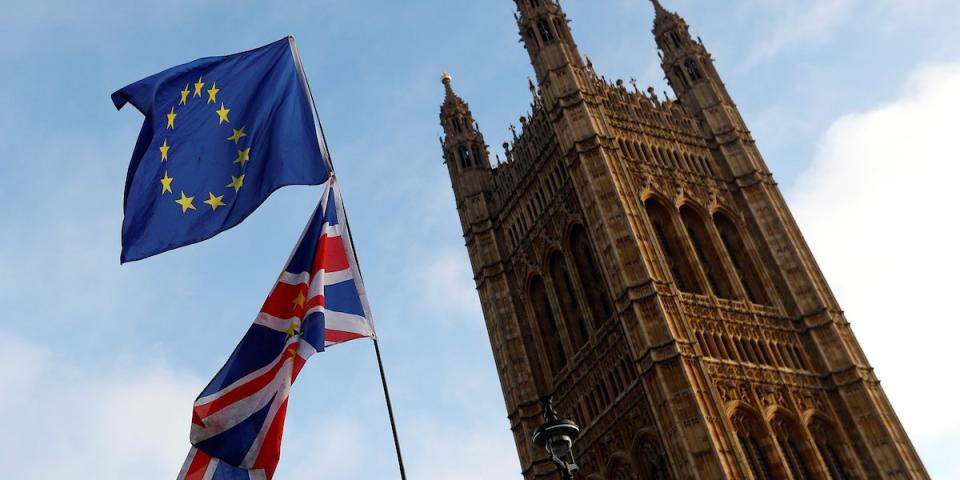 Protesters wave the EU and Union flags outside the Palace of Westminster, London, Britain, December 20, 2017