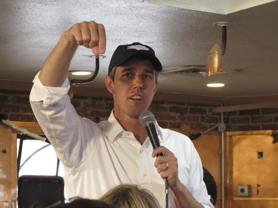 Former Texas Rep. Beto O'Rourke dons a Nevada Wolf Pack hat as he talks to an over-flowing crowd that jammed a coffee shop on the edge of the University of Nevada, Reno campus on Thursday, April 25, 2019. He brought his Democratic presidential campaign to the early caucus state for the second time this year. He told reporters afterward he's glad former Vice President Joe Biden has joined what he says is already an extraordinary field of candidates. (AP Photo/By Scott Sonner)