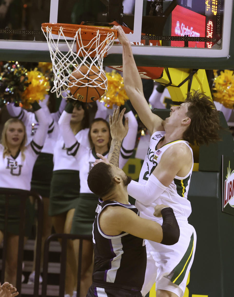 Baylor guard Matthew Mayer scores over Kansas State forward Davion Bradford, left, in the first half of an NCAA college basketball game, Tuesday, Jan. 25, 2022, in Waco, Texas. (Rod Aydelotte/Waco Tribune Herald, via AP)