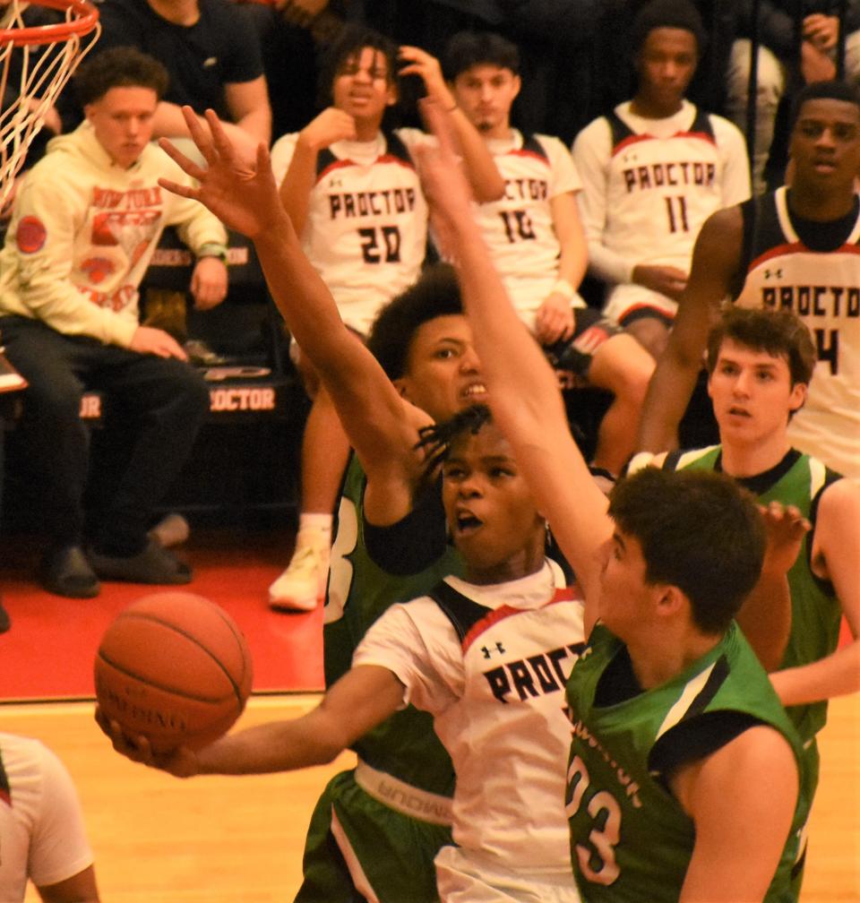 Proctor senior Marc Simmons shoots amid a trio of Bishop Ludden defenders during the fourth quarter of Saturday Section III quarterfinal in Utica.