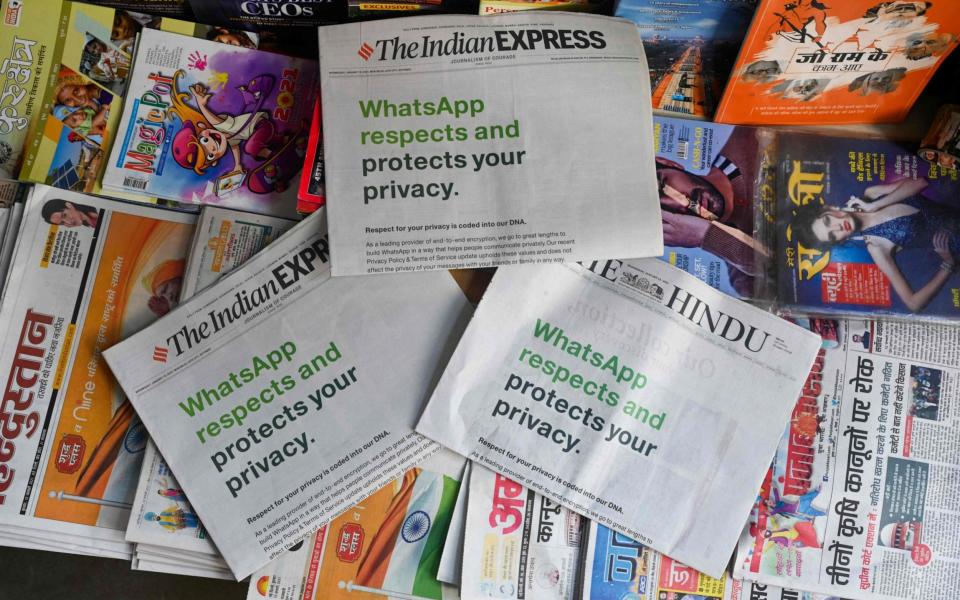 An advertisement from WhatsApp is seen in a newspaper at a stall in New Delhi on January 13, 2021 - Sajjad Hussain/AFP