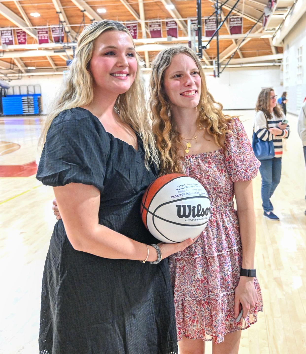 FALMOUTH 05/03/24 Dave Whiteside Scholarship recipient Teagan Lind (right) joins his daughter Carly Whiteside in the Falmouth field house with the ball Lind signed with others who received the award. 73508699007
Ron Schloerb/Cape Cod Times