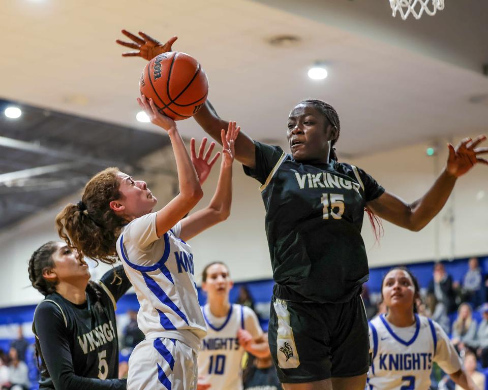 Navarro forward Paulete Mbuangi soars and blocks McCallum's Miranda DiGiovanni in their Jan. 19 game. Mbuangi has led Navarro into the Class 5A state playoffs, which begin Monday.