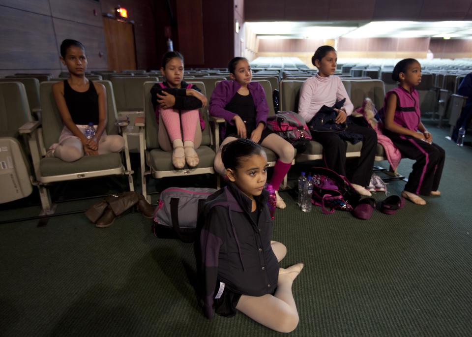 In this Sept. 3, 2012 photo, ballet dancers from Venezuela's Nueva Era del Ballet school sit in the National Museum as they watch others practice for a competition between ballet schools in Lima, Peru. Nearly 100 girls and boys from Colombia, Venezuela, Chile, France and Peru are submitting themselves to a week-long competition hoping to win medals from Peru's national ballet school _ and perhaps a grant to study in Miami. (AP Photo/Martin Mejia)