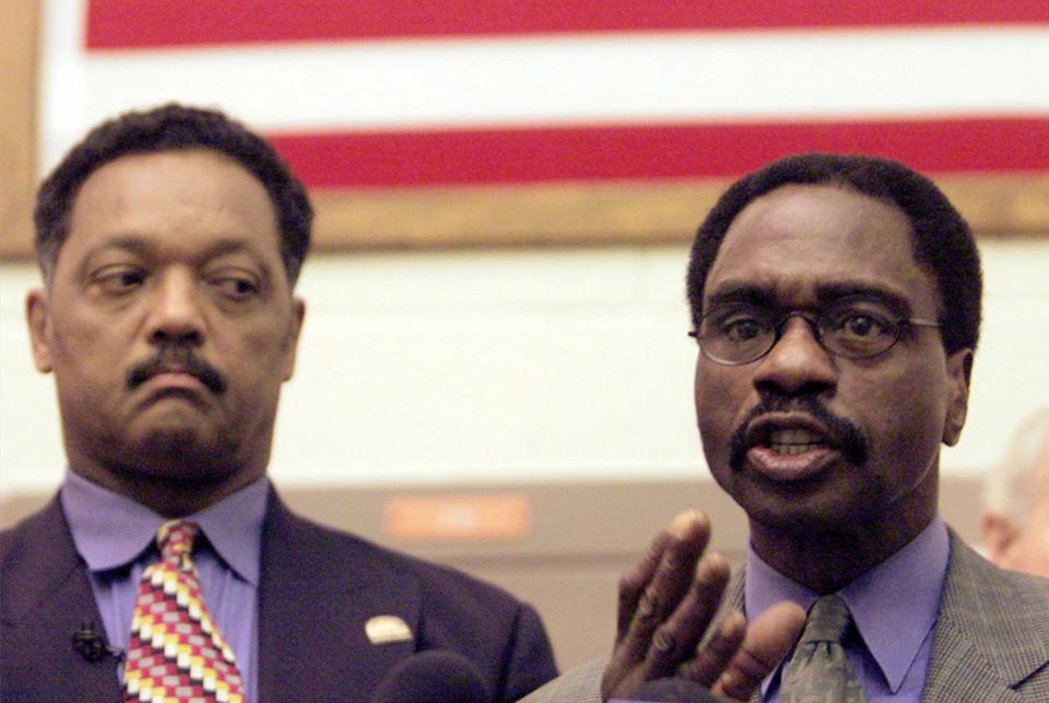 FILE - In this March 3, 2000 file photo, the Rev. Jesse Jackson, left, listens as Rubin "Hurricane" Carter, the former middleweight boxer, speaks during a news conference inside the North County Correctional Facility in Castaic, Calif. Carter, who spent almost 20 years in jail after twice being convicted of a triple murder he denied committing, died at his home in Toronto, Sunday, April 20, 2014, according to long-time friend and co-accused John Artis. He was 76. (AP Photo/Damian Dovarganes, File)