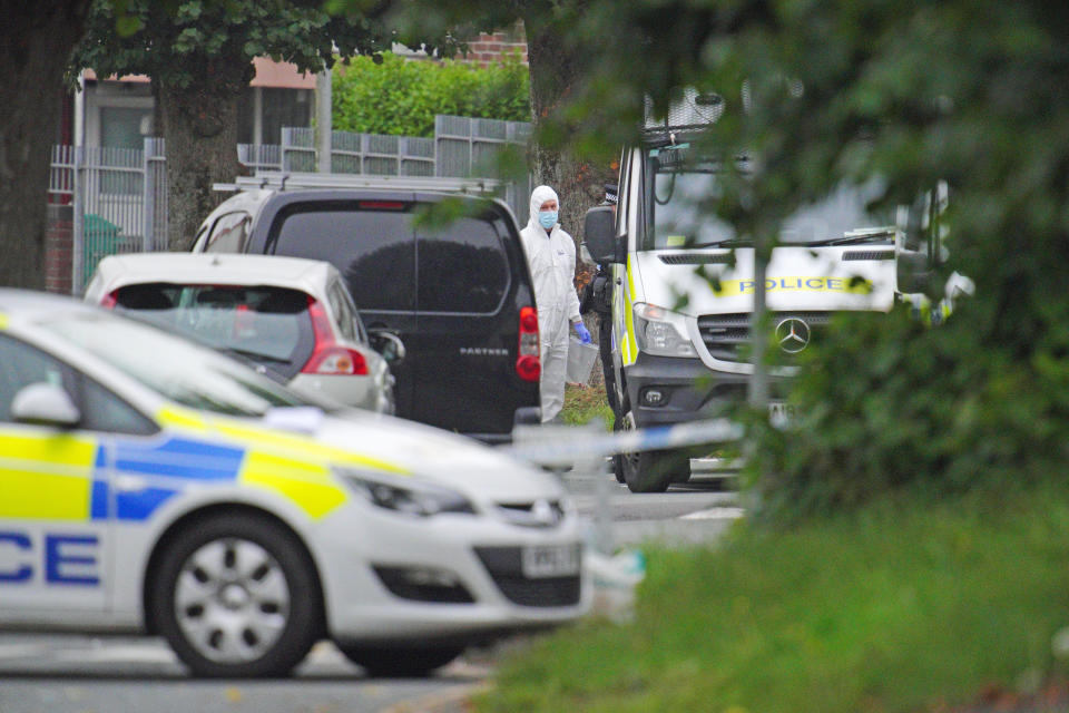 A police investigator carries an evidence bag in Royal Navy Avenue in the Keyham area of Plymouth where six people, including the offender, died of gunshot wounds in a firearms incident Thursday evening. Picture date: Friday August 13, 2021.