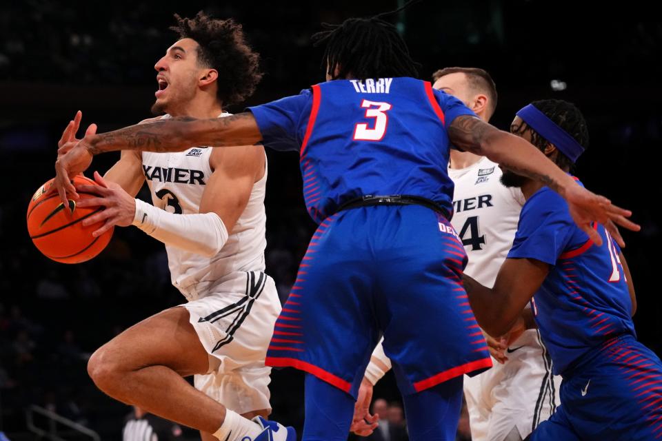 Xavier Musketeers guard Colby Jones (3) is stripped of possession by DePaul Blue Demons guard Jalen Terry (3) in the first half of an NCAA college basketball game during the second round of the Big East conference tournament, Thursday, March 9, 2023, at Madison Square Garden in New York. 