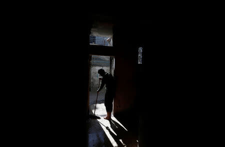 A Palestinian man cleans his house at Shati refugee camp in Gaza City March 14, 2018. REUTERS/Mohammed Salem