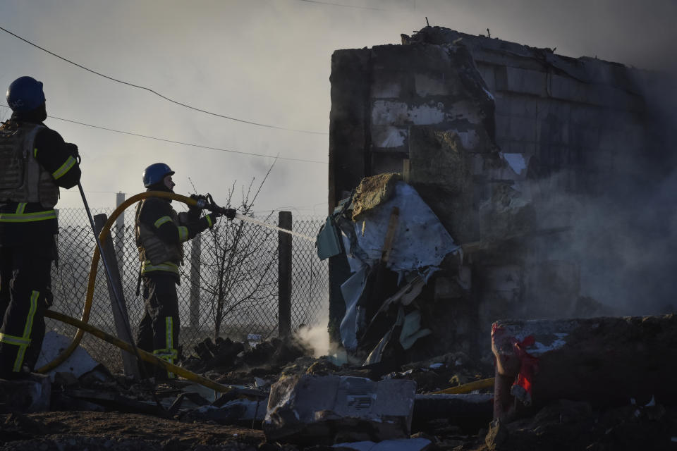 Members of the Ukrainian State Emergency Service clear the rubble at the building which was destroyed as a result of Russian strike in Zaporizhzhia district, Ukraine, Friday, March 31, 2023. (AP Photo/Andriy Andriyenko)