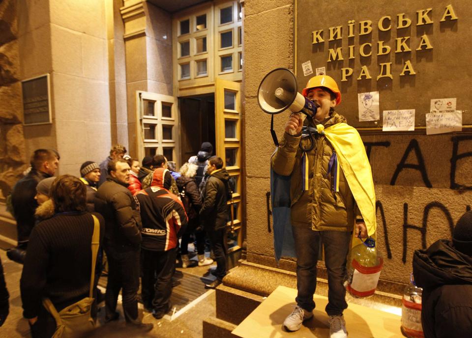 A protester uses a megaphone to speak to others entering the occupied Kiev city hall