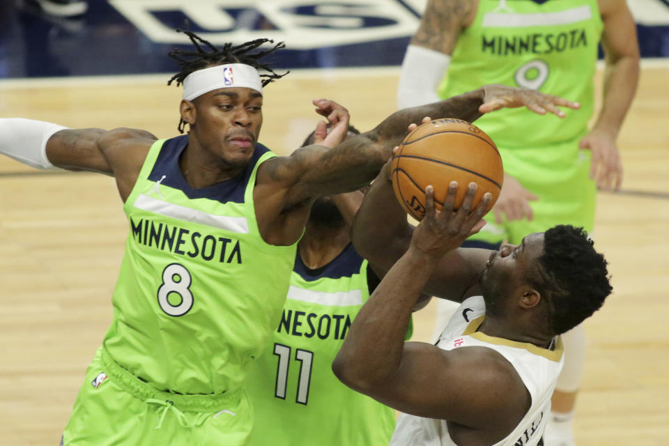 Minnesota Timberwolves forward Jarred Vanderbilt (8) defends against New Orleans Pelicans forward Zion Williamson (1) in the second quarter during an NBA basketball game, Saturday, Jan. 23, 2021, in Minneapolis. (AP Photo/Andy Clayton-King)