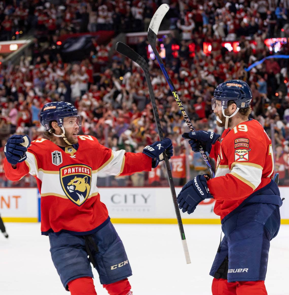 Florida Panthers left wing Matthew Tkachuk (19) celebrates with center Carter Verhaeghe (23) after scoring a goal to tie the game against the Vegas Golden Knights in the third period of Game 3 of the NHL Stanley Cup Final at the FLA Live Arena on Thursday, June 8, 2023, in Sunrise, Fla.