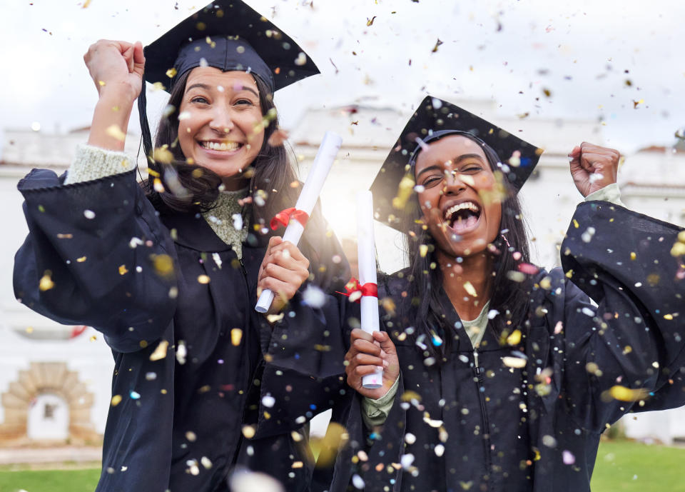 College grads celebrating with their diplomas