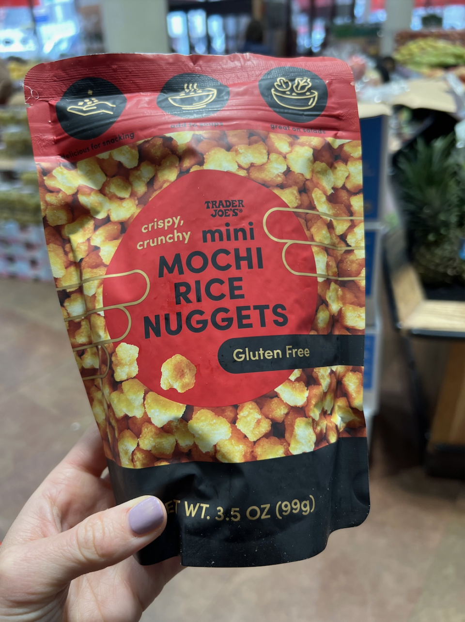 Hand holding a packet of Trader Joe's Mini Mochi Rice Nuggets, gluten-free