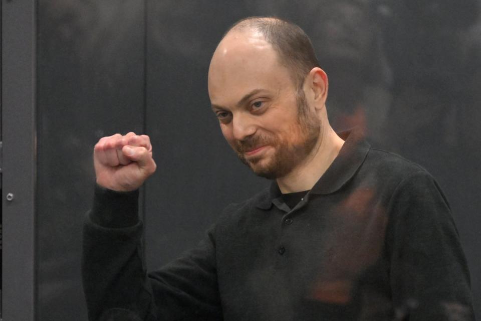 Vladimir Kara-Murza gestures from behind a glass cage in a Moscow courtroom last year (AP)