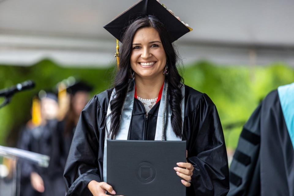 A happy graduate receives her diploma during a commencement ceremony at Davidson-Davie Community College on Thursday.