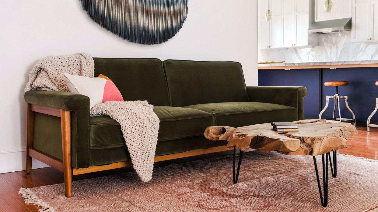 a couch with a table and a coffee table in a room