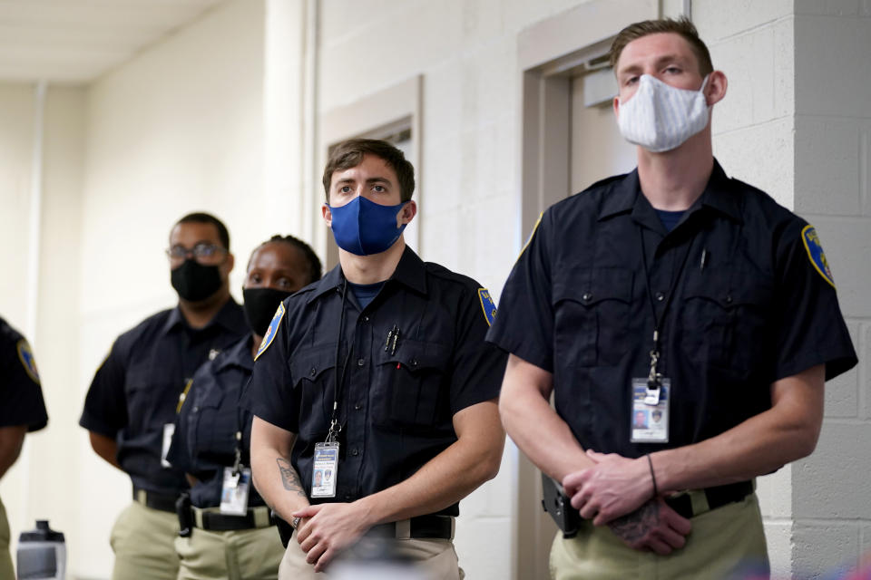 In this Sept. 9, 2020, photo Zachary Ruhling, center, a cadet in the Baltimore Police Academy, watches a video presentation during a class session focusing on procedural justice in Baltimore. (AP Photo/Julio Cortez)