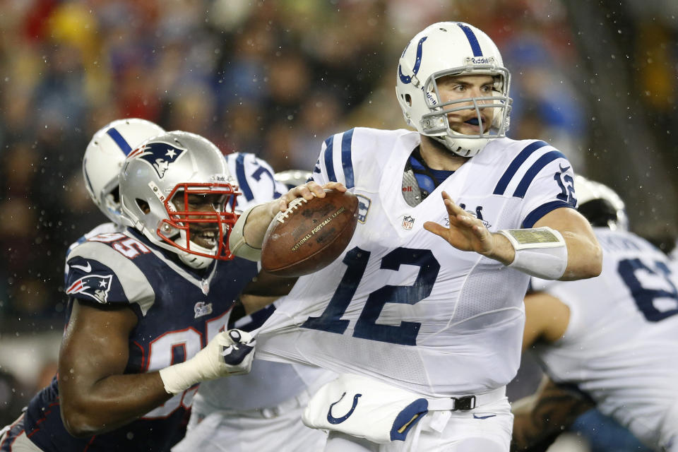 New England Patriots defensive end Chandler Jones (95) grabs the jersey of Indianapolis Colts quarterback Andrew Luck (12) as Luck looks for an opening to pass during the first half of an AFC divisional NFL playoff football game in Foxborough, Mass., Saturday, Jan. 11, 2014. (AP Photo/Michael Dwyer)