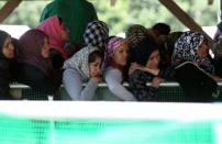 Women queue for food at a gas station near the Greek-Macedonian border on May 25, 2016 in Polykastro as Greek police evacuate the sprawling Idomeni migrant camp