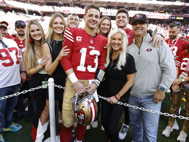 <p>Michael Zagaris/San Francisco 49ers/Getty</p> Brock Purdy with his family before the game against the Arizona Cardinals at State Farm Stadium on December 17, 2023.