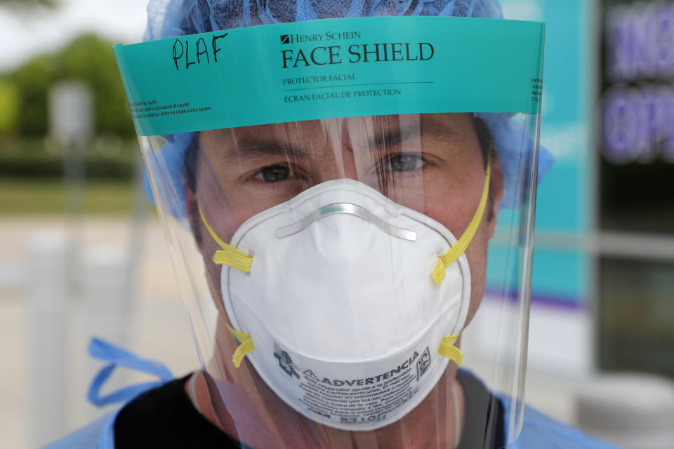 Registered nurse Patrick LaFontaine poses for a photo after helping set up a COVID-19 testing station for pre-screened pediatric patients outside a Children's Health PM Urgent Care facility, Thursday April 2, 2020, in Richardson, Texas. (AP Photo/Tony Gutierrez)