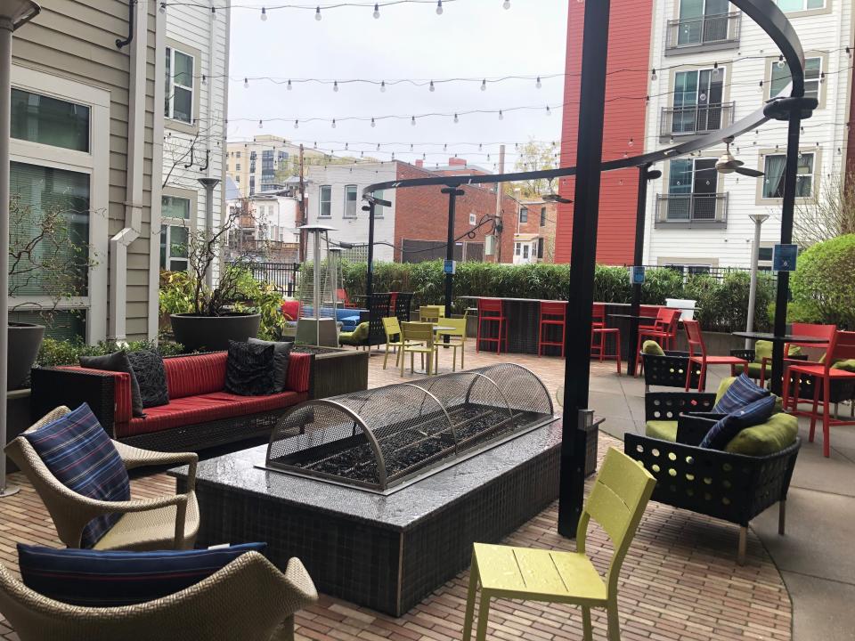 The communal outdoor space at AVA in dc with firepit and chairs and string lights