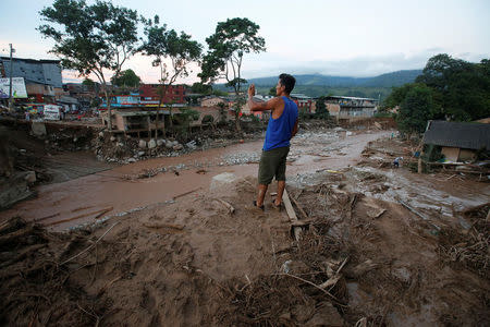 A man looks at a destroyed area after heavy rains caused several rivers to overflow, pushing sediment and rocks into buildings and roads in Mocoa, Colombia April 1, 2017. REUTERS/Jaime Saldarriaga