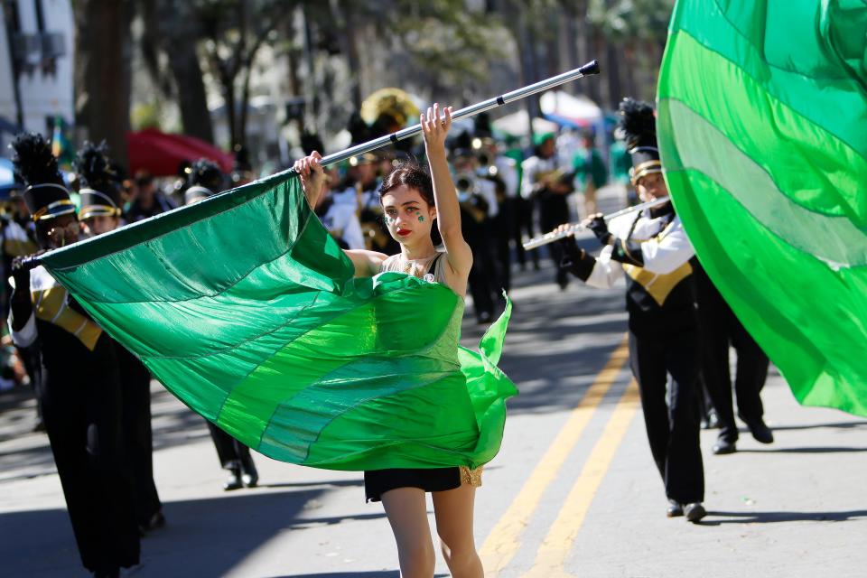 A member of the Bishop Moore Catholic High School Black and Gold Brigade performs during the Savannah St. Patrick's Day Parade in Savannah, GA Thursday, March 17, 2022.