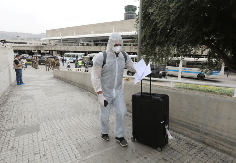 A Lebanese, who was stranded abroad by coronavirus lockdowns, is pictured wearing protective gear upon his arrival at Beirut's international airport