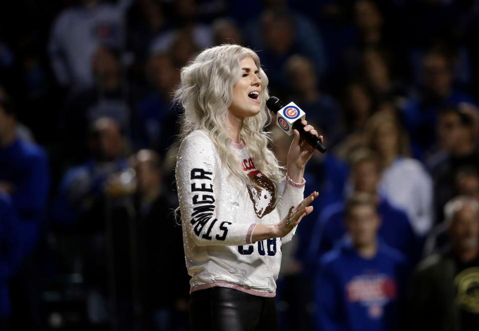 The Chicago Cubs' Ben Zobrist's wife, Julianna Zobrist, performs the national anthem before Game 4 of baseball's National League Championship Series between the Chicago Cubs and the Los Angeles Dodgers on Oct. 18, 2017, in Chicago.