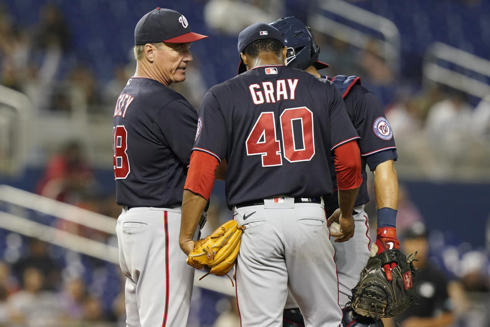 Washington Nationals pitching coach Jim Hickey (48) talks to pitcher Josiah Gray (40) and catcher Alex Avila during the sixth inning of a baseball game against the Miami Marlins, Wednesday, Sept. 22, 2021, in Miami. (AP Photo/Marta Lavandier)