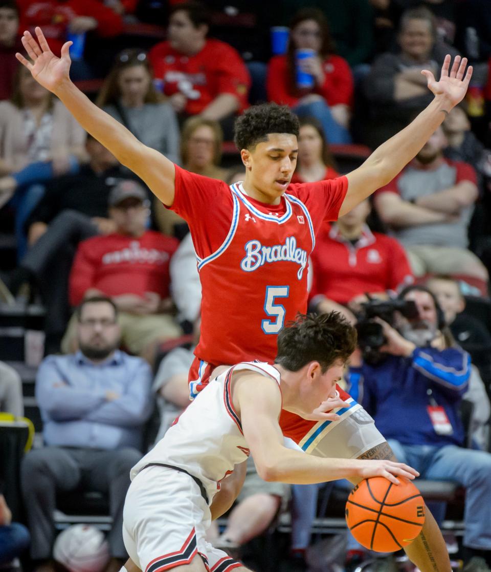 Illinois State's Johnny Kinziger runs up against Bradley's Christian Davis in the second half of their Missouri Valley Conference basketball game in February.