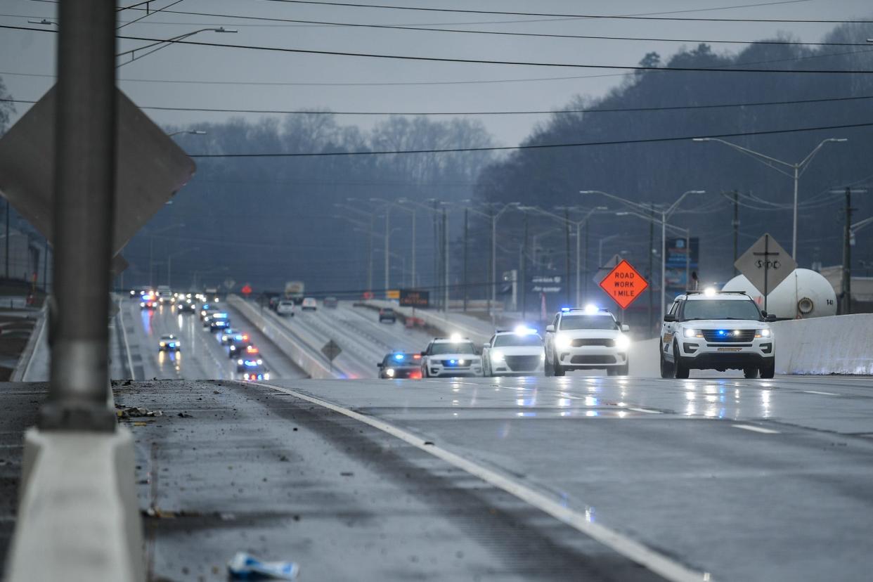 A procession of police vehicles temporarily halted traffic after the hearse carrying deputy Greg McCowan, who was killed in action overnight, was driven down Alcoa Highway followed by a police cavalcade, Friday, Feb. 9, 2024. Along with deputy Shelby Eggers who survived her injuries, McCowan was fatally shot after performing a traffic stop in Maryville.