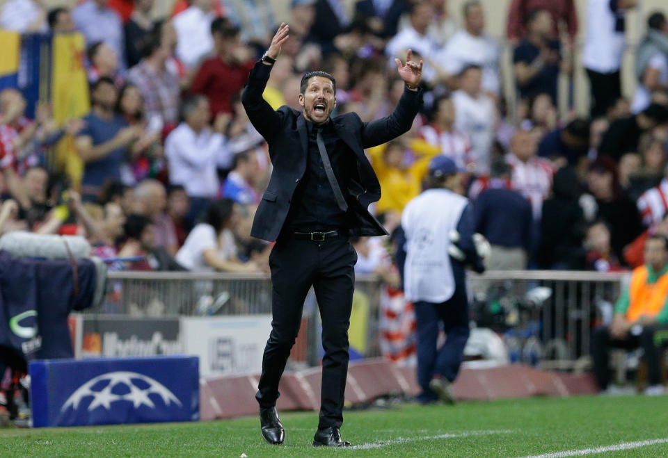 Atletico's coach Diego Simeone gestures during the Champions League quarterfinal second leg soccer match between Atletico Madrid and FC Barcelona in the Vicente Calderon stadium in Madrid, Spain, Wednesday, April 9, 2014. (AP Photo/Paul White)