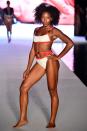 <p>A model hits the runway wearing a red-and-white sporty buckle bikini for the 2018 <em>Sports Illustrated</em> swimsuit show during Miami Swim Week at the W South Beach hotel on July 15. (Photo: Alexander Tamargo/Getty Images for Sports Illustrated) </p>