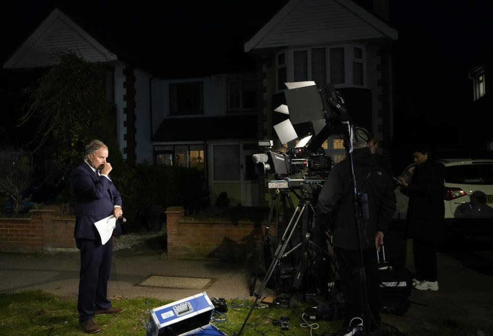 A member of the media prepares to do a piece to camera near the Belfairs Methodist Church in Eastwood Road North, where British Conservative lawmaker David Amess has died after being stabbed at a constituency surgery, in Leigh-on-Sea, Essex, England, Friday, Oct. 15, 2021. Police gave no immediate details on the motive for the killing of 69-year-old Conservative lawmaker Amess and did not identify the suspect, who was being held on suspicion of murder. (AP Photo/Kirsty Wigglesworth)