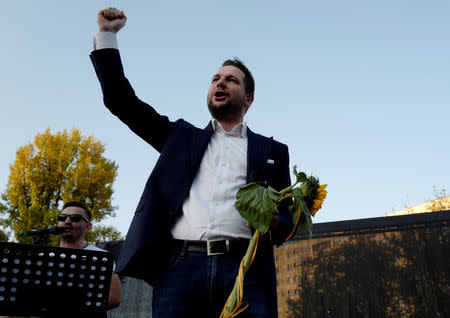 Patryk Jaki, United Right (Law and Justice (PiS), Solidarna Prawica and Polska Razem) candidate for mayor in Warsaw, sings song with a rap musician as he meets his supporters during an election meeting in Warsaw, Poland September 19, 2018. REUTERS/Kacper Pempel/File Photo