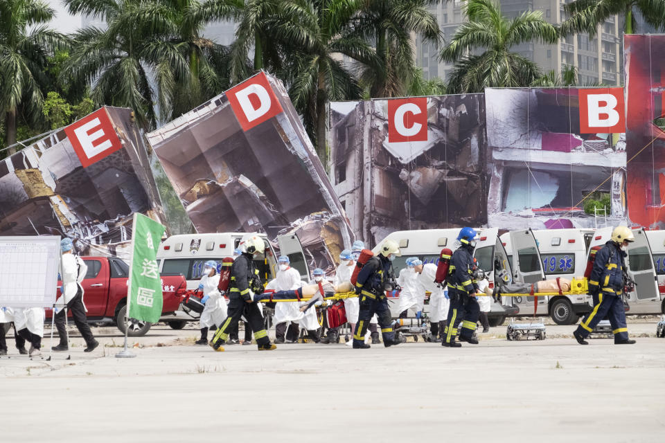 Firefighters and medical personnel carry dummy victims on stretchers during a drill in New Taipei City, Taiwan on July 14, 2022. While an invasion doesn’t appear imminent, China's recent large-scale military exercises in response to a visit by U.S. House Speaker Nancy Pelosi to Taiwan have made the government in Taipei more aware than ever of the hard power behind Beijing’s rhetoric about bringing the self-ruled island under its control. Experts said that civilian defense and reserve forces have an important deterrent effect, showing a potential aggressor that the risks of invasion are high. (AP Photo/Huizhong Wu)