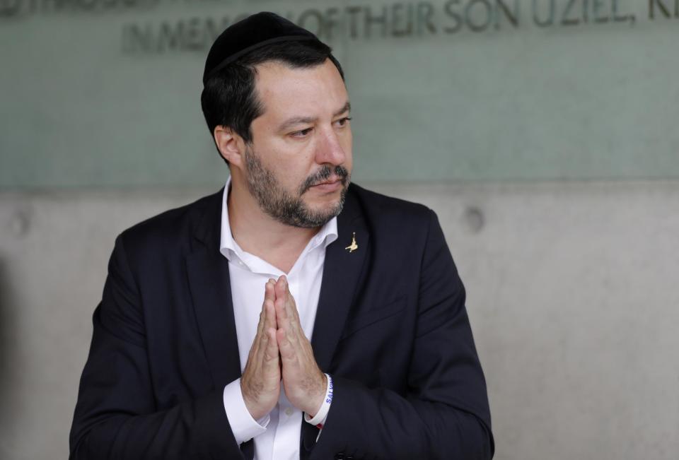 Italy's Interior Minister and Deputy Prime Minister Matteo Salvini (C) gestures after signing the guest book during his visit to the Yad Vashem Holocaust Memorial museum in Jerusalem,: AFP