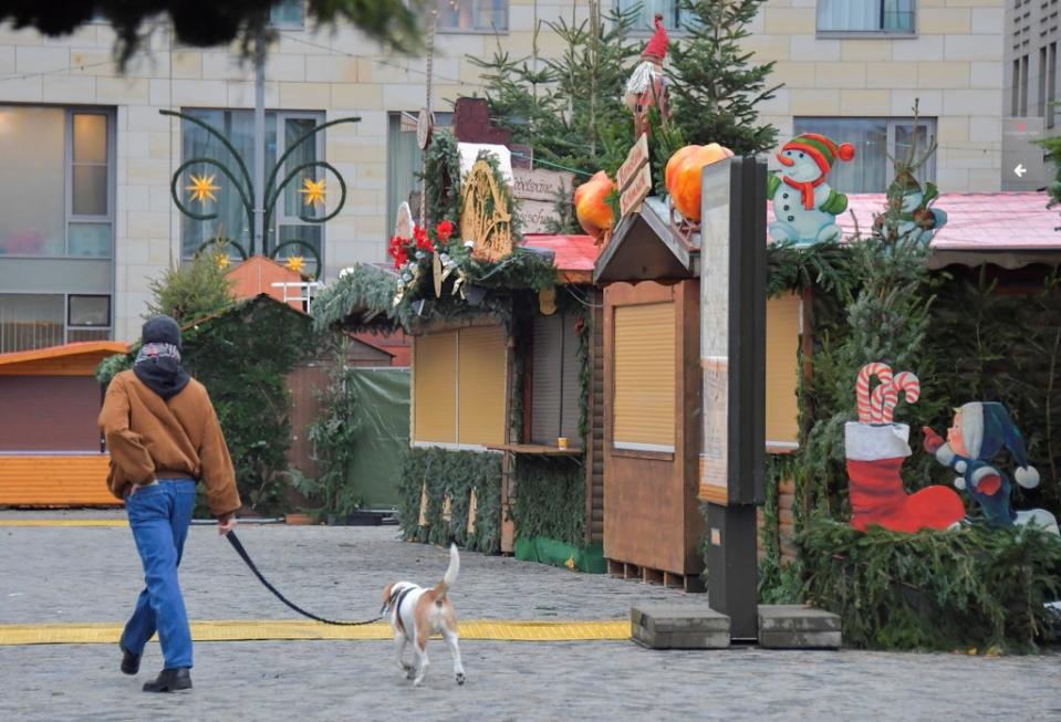 A man walks through the closed Christmas market in Dresden, Germany (REUTERS)