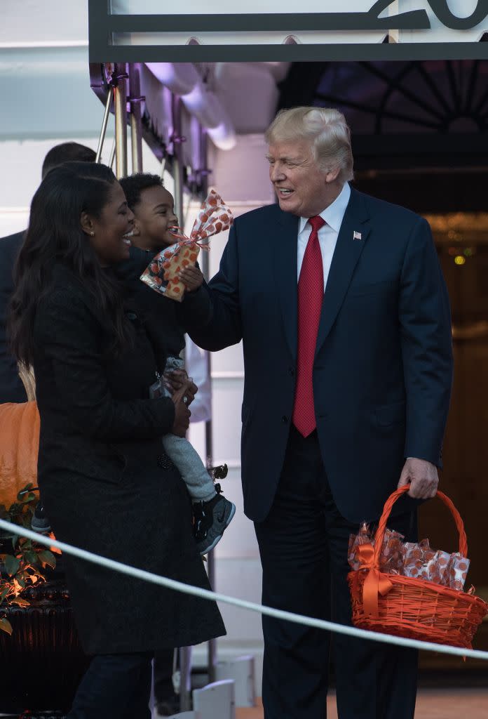 US President Donald Trump speaks with aide Omarosa Manigault as he hands out candy to children during a Halloween event. Source: Getty