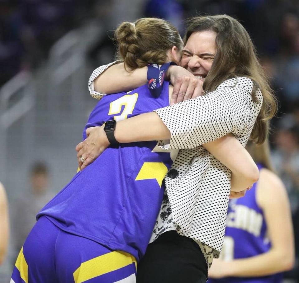 Berean Academy girls basketball coach Kristin Wiebe hugs her daughter, Avery, after winning the Class 2A state championship.